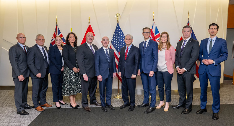 Five Eyes Law Enforcement Group group photo of 11 people standing in a row