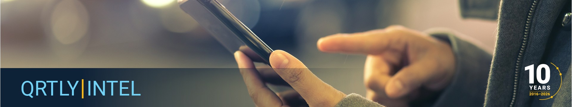 view of the hands of a person in a suit jacket using a mobile phone